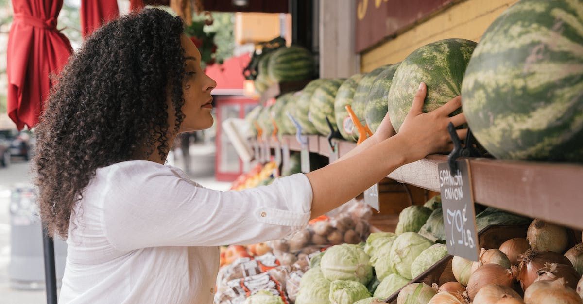 What does the middle side in the fifa 14 choosing controls mean? - Woman Wearing a White Top Choosing Watermelons in a Fruit Stand