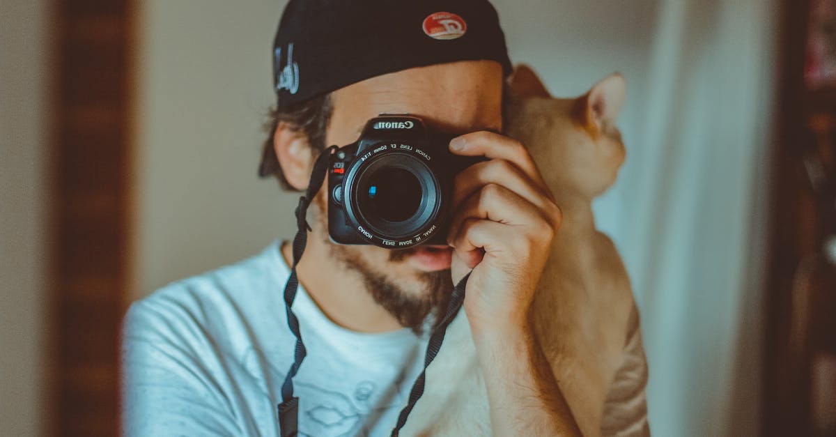 What does the "Dismiss familiar" button do when it is a pet? - Young man with cat and taking photo on camera What does the "Dismiss familiar" button do when it is a pet? - Young man with cat and taking photo on camera