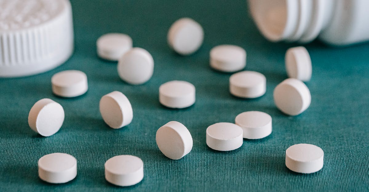 What does the size of the multicoloured circle mean? - White pills spilled on table