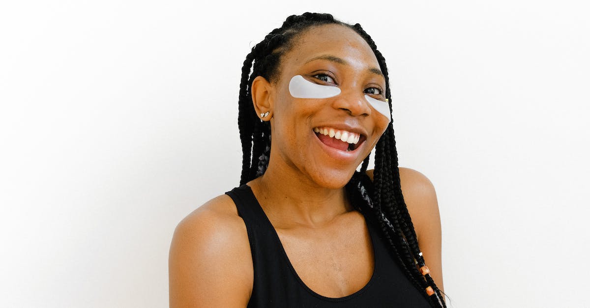 What does the Time Goddess look into when she wants to look into "memory of that time"? - Cheerful African American female with eye patches and amazing gaze laughing and looking at camera