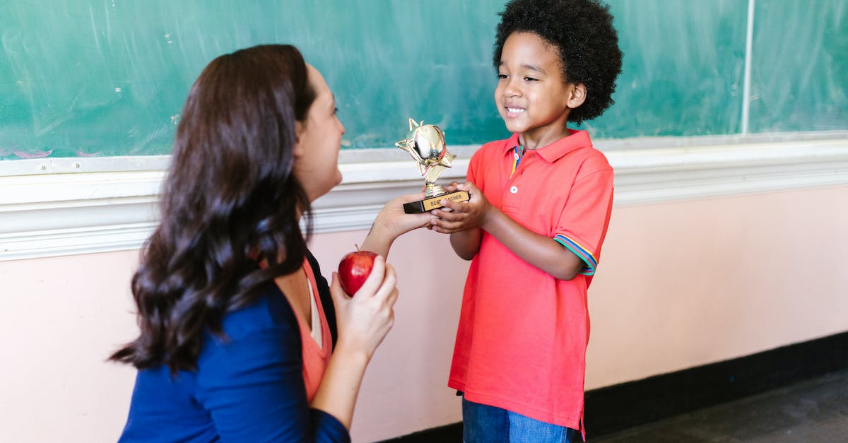 What does the trophy do in extinction? - Little Boy in Red Polo Shirt Holding Gold Trophy