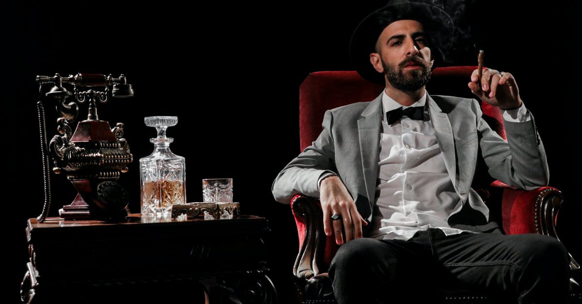 What does this 'Bottomless Carafe' do? - Man in Gray Suit Sitting on Red Sofa Chair What does this 'Bottomless Carafe' do? - Man in Gray Suit Sitting on Red Sofa Chair