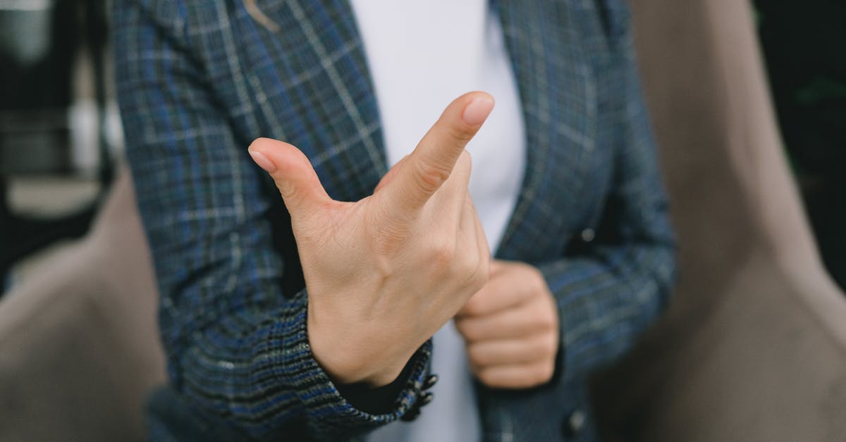 What does this symbol mean in the Starcraft chat portrait? - Crop anonymous lady in elegant blazers sitting in comfortable armchair and showing index finger while communicating using sign language What does this symbol mean in the Starcraft chat portrait? - Crop anonymous lady in elegant blazers sitting in comfortable armchair and showing index finger while communicating using sign language