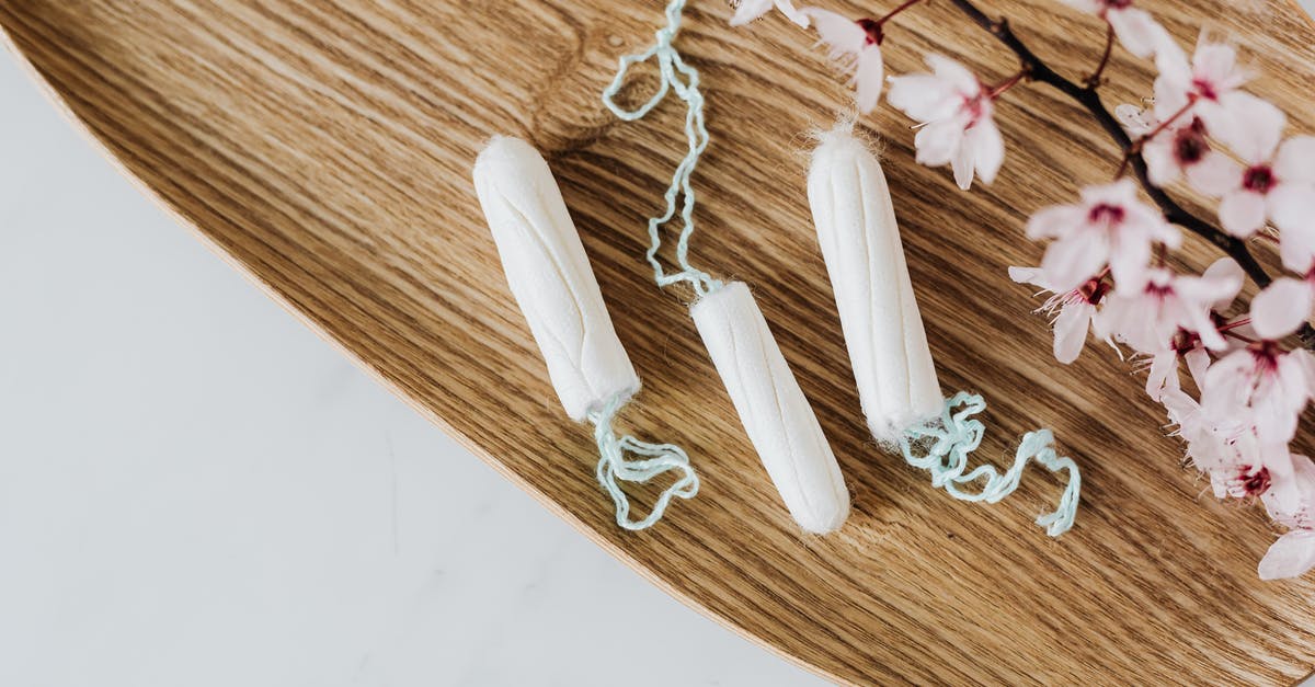 What exactly is a Humble Monthly Sneak Peek? - From above of hygienic cotton tampons placed on bamboo board with small pink flowers