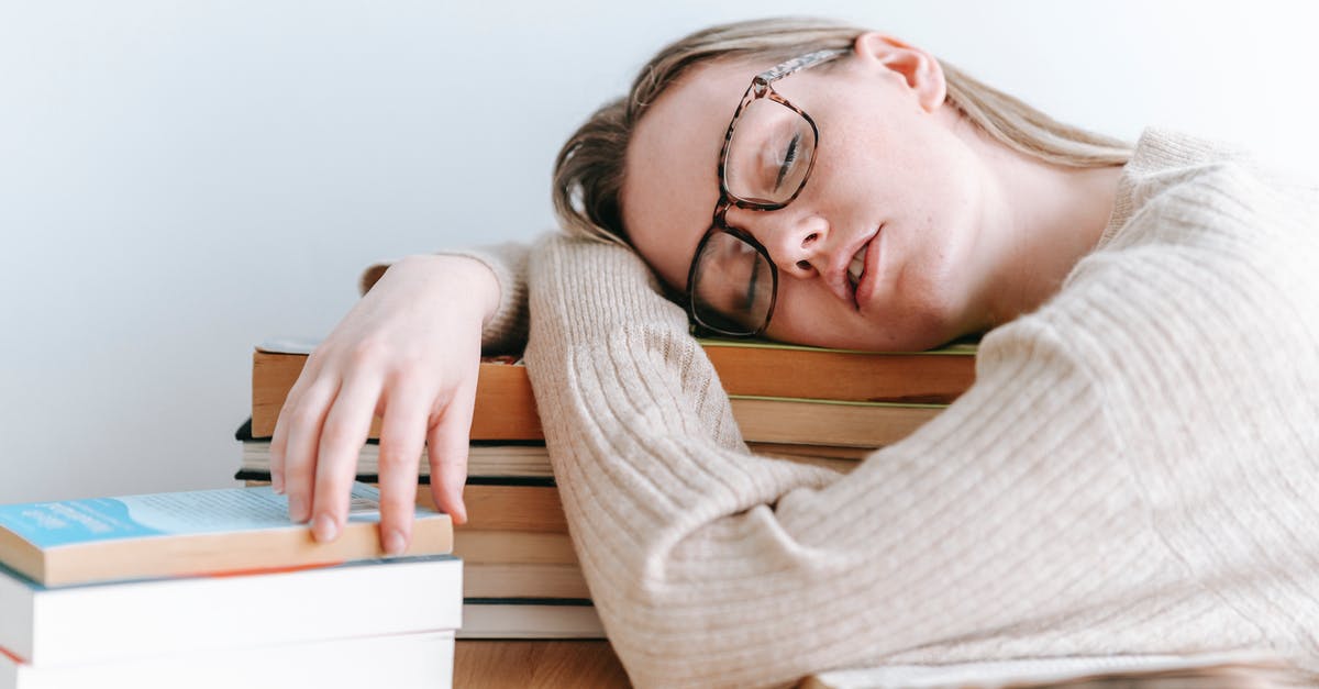What examples of games break the fourth wall and direct the player to read the manual? [closed] - Exhausted female student in eyeglasses and casual sweater sitting at table and sleeping on books on light room