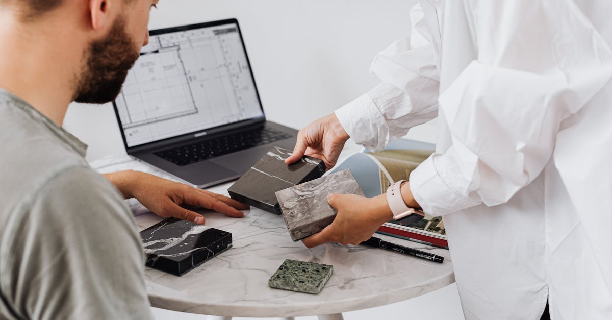 What factors should be considered when choosing one agent over another? - Interior Designers Looking at Tile Samples What factors should be considered when choosing one agent over another? - Interior Designers Looking at Tile Samples