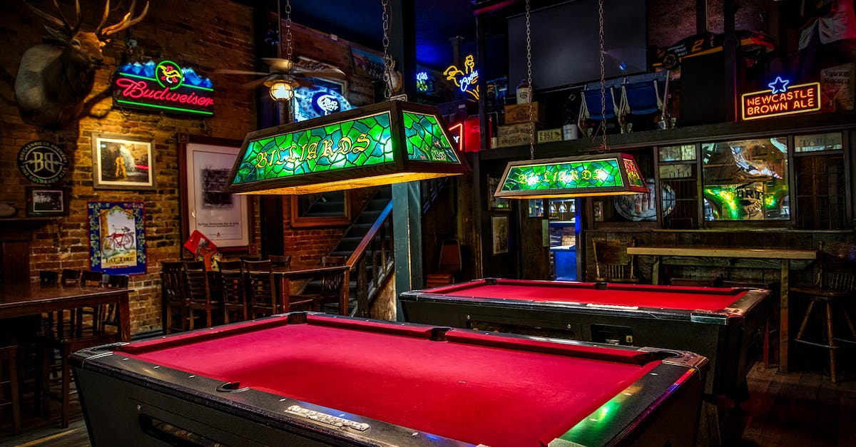 What game does this screenshot of a western saloon/bar belong to? - Brown and Red Billiards Tables With Green Lamps What game does this screenshot of a western saloon/bar belong to? - Brown and Red Billiards Tables With Green Lamps