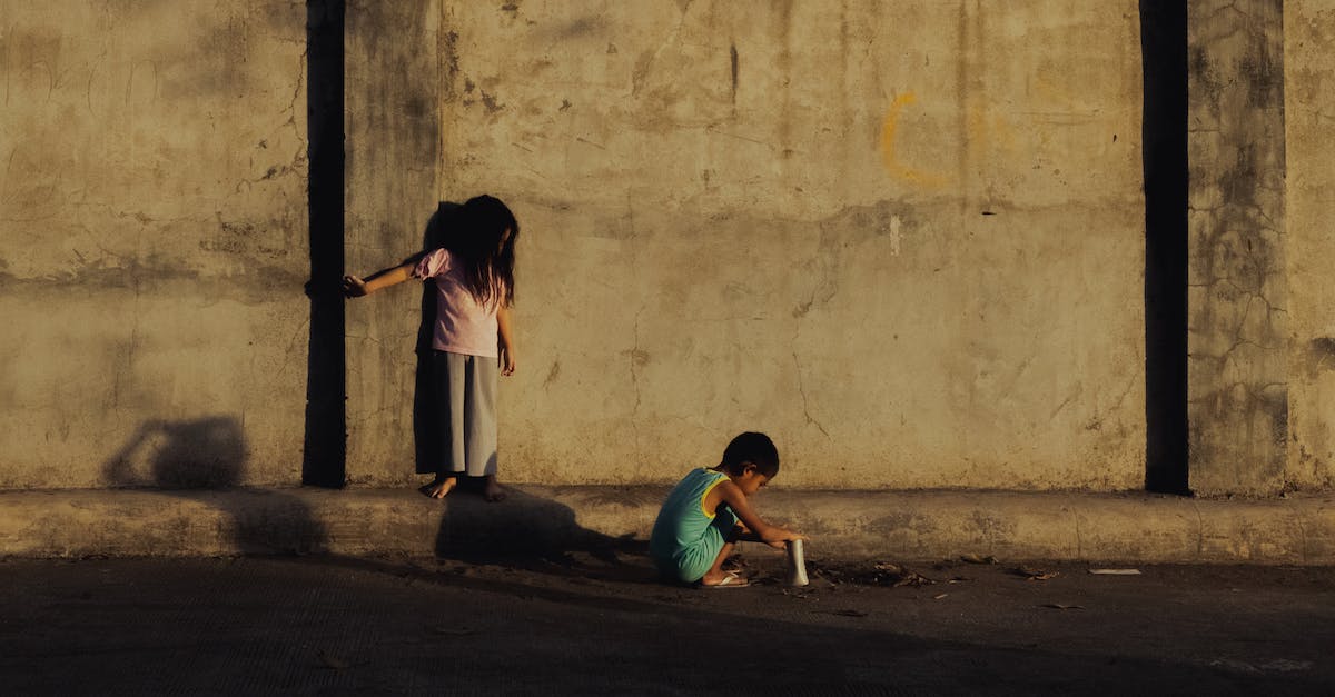 What game modes are available for local multiplayer? - Side view of full body diverse children in casual clothes playing near shabby concrete wall What game modes are available for local multiplayer? - Side view of full body diverse children in casual clothes playing near shabby concrete wall