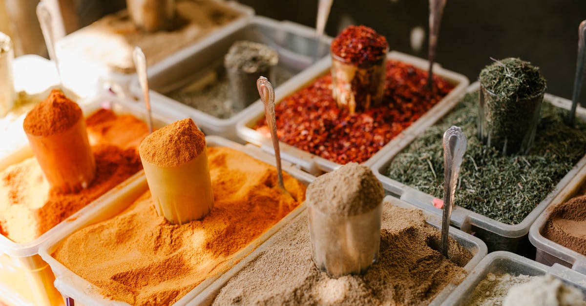 What governs the availability of trade goods? - Assorted spices at counter in street market What governs the availability of trade goods? - Assorted spices at counter in street market