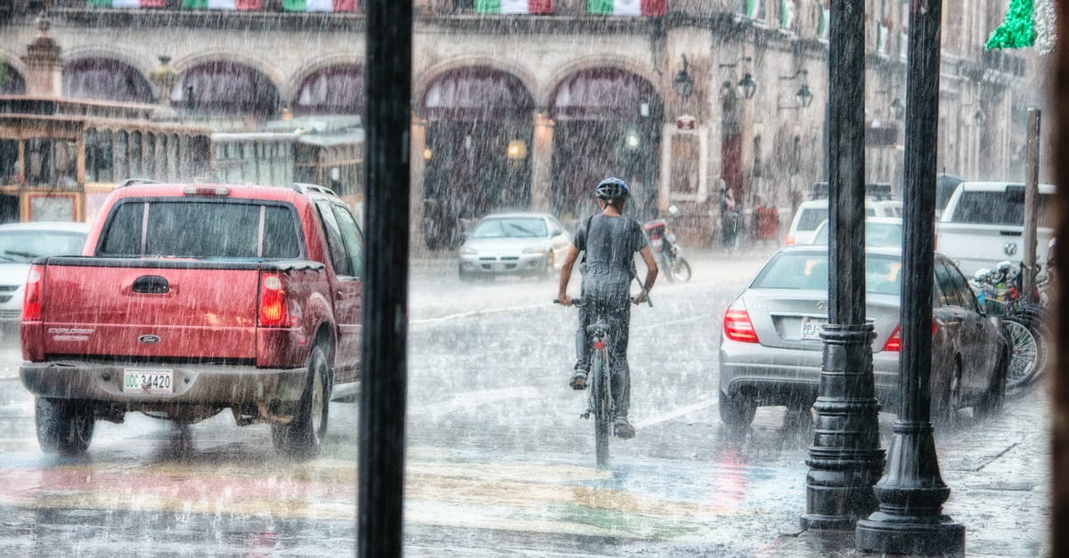 What happened to the flood? - Person Riding a Bicycle during Rainy Day