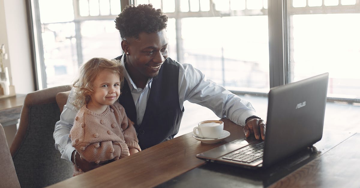 What happened to the shipwrecked guy after Delfino Plaza is flooded? - Cheerful black man in formal wear sitting together with cute child of diverse colleague at table with cup of coffee and using laptop in modern cafeteria during daytime