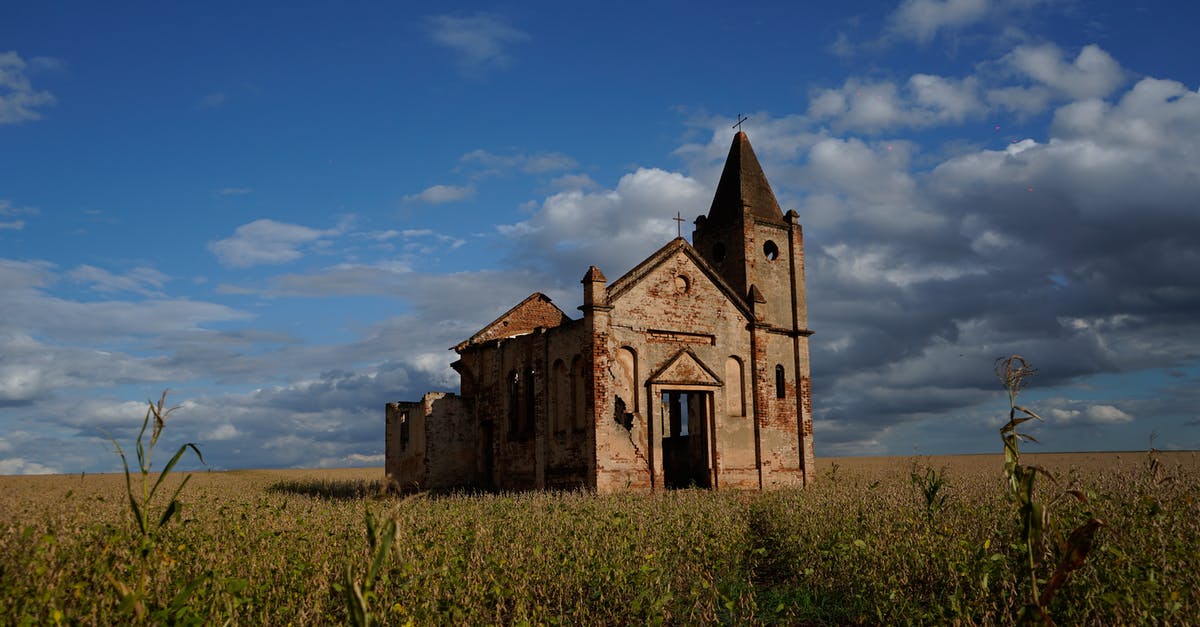 What happens if I demolish a monument that I constructed? - Exterior of ruined medieval church with remaining masonry walls and crosses on top located on spacious grassy valley
