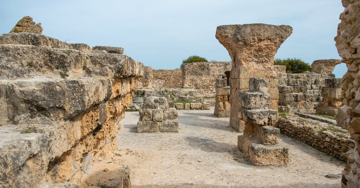 What happens if I demolish a monument that I constructed? - Famous remains of old historic stones with ruined columns located on street against cloudless sky located in Tunisia in Turkey