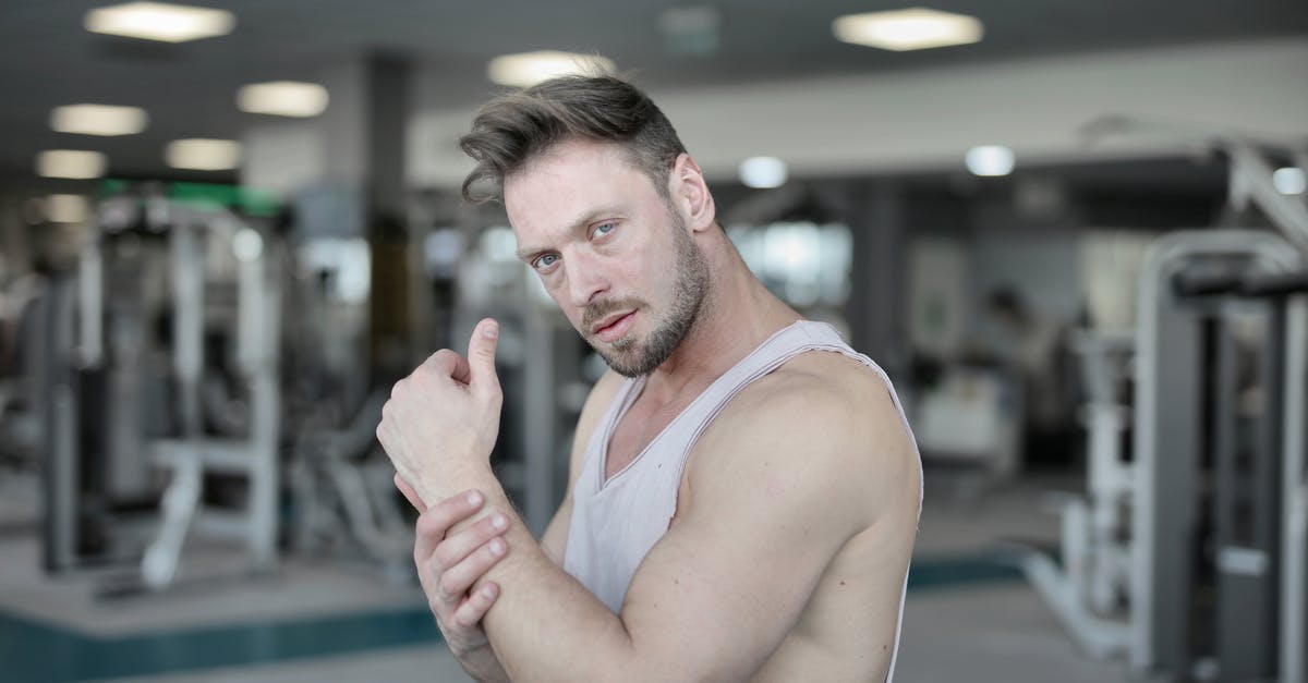 What happens if you destroy a Dungeon chest that hasn't generated loot? - Serious male athlete standing in gym and looking at camera