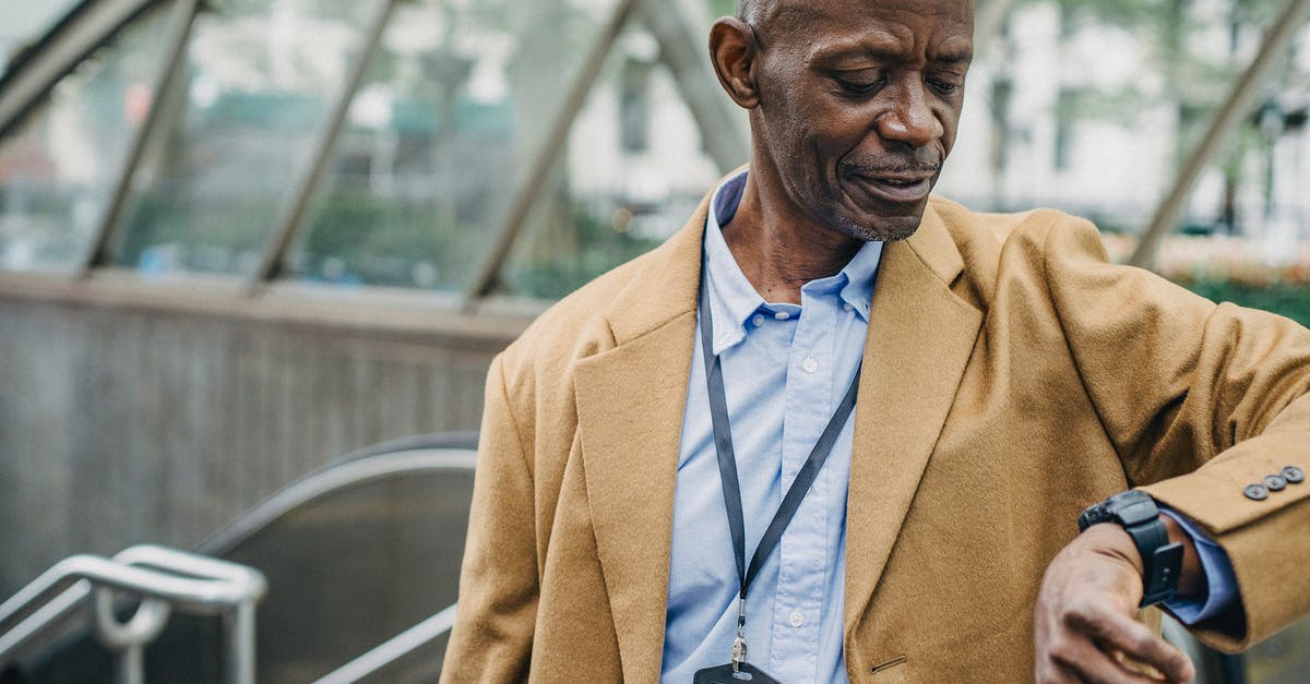What happens if you wait 18 hours? - Crop punctual African American male in elegant formal clothes standing near metro entrance and checking time on wristwatch What happens if you wait 18 hours? - Crop punctual African American male in elegant formal clothes standing near metro entrance and checking time on wristwatch