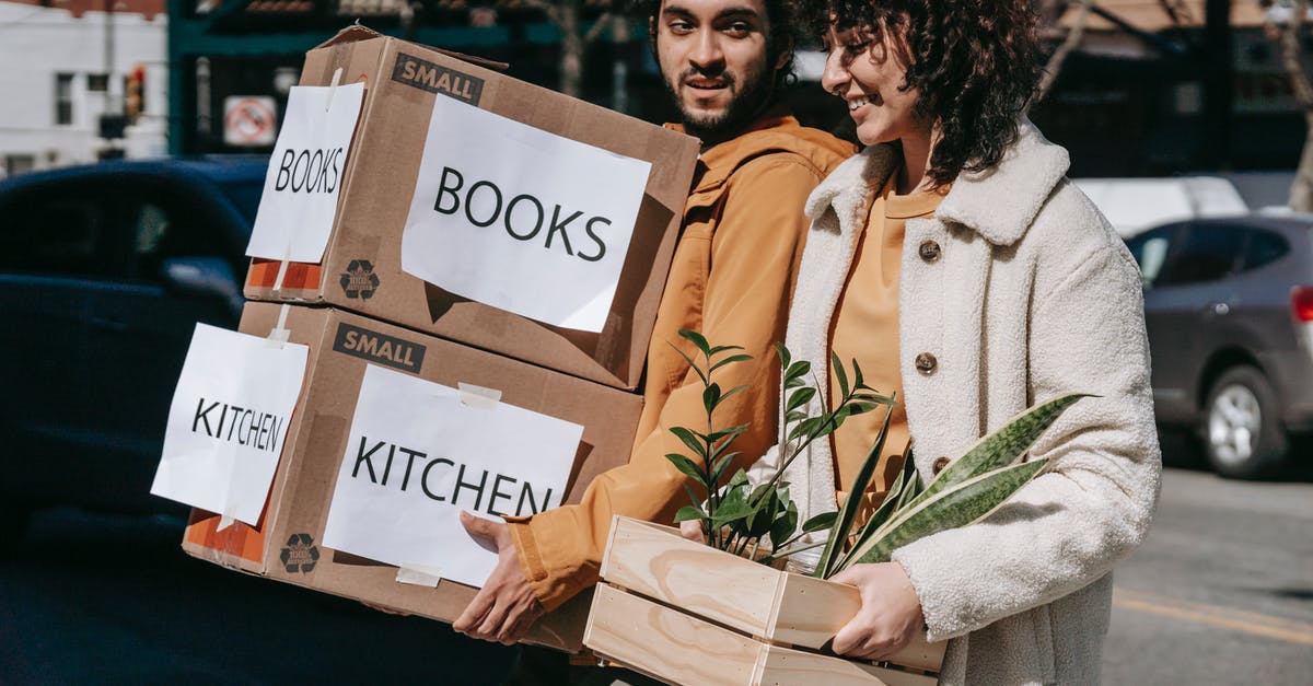 What happens to Awakening Values after transferring Pokémon into Home? - Man Carrying Boxes And Woman Holding A Box Of Plants