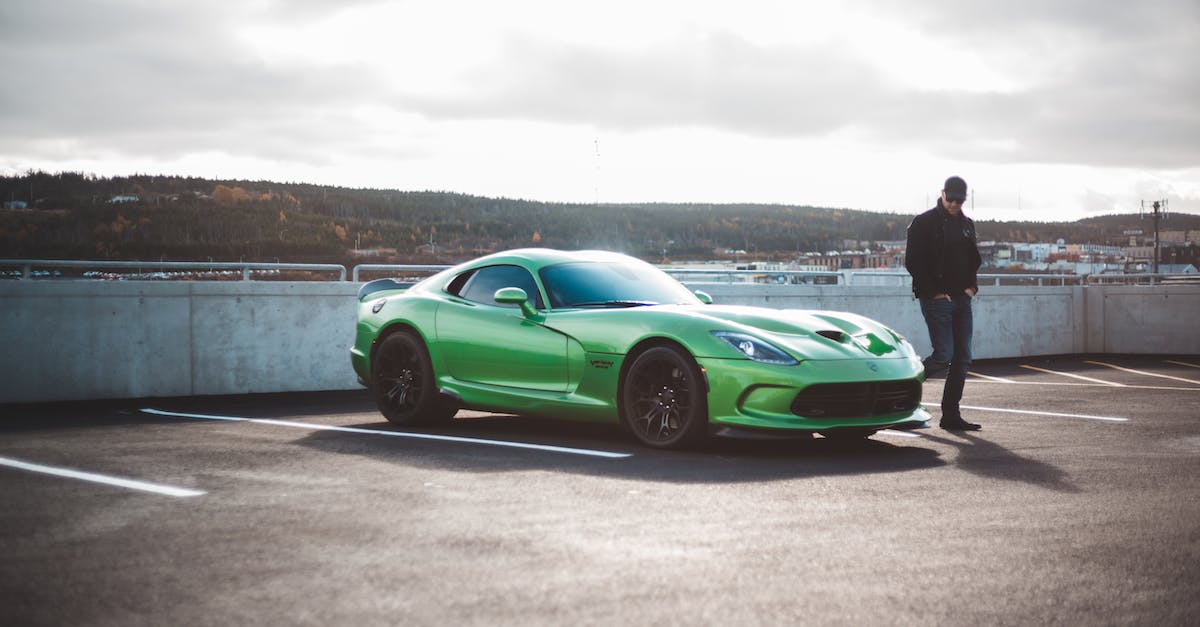 What happens to custom vehicles if the impound lot is full? - Unrecognizable man strolling near bright sport car on parking lot