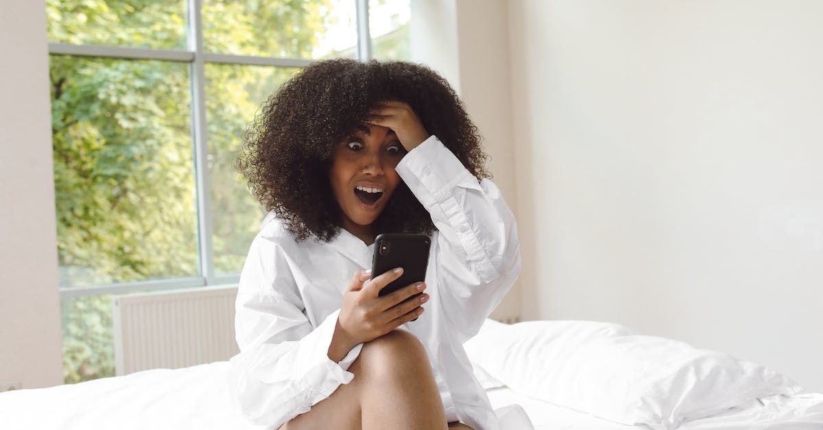 What happens to stunned civilians? - Photo of a Surprised Woman Holding Her Black Cellphone