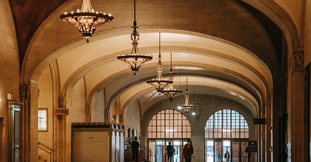 What happens when a vault dweller levels? - Aged house interior with shiny passage and columns under arched vaults with hanging chandeliers above unrecognizable people What happens when a vault dweller levels? - Aged house interior with shiny passage and columns under arched vaults with hanging chandeliers above unrecognizable people