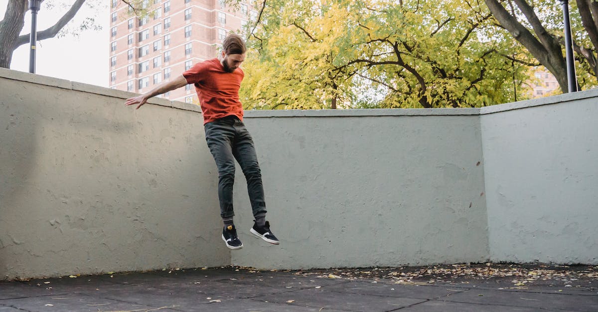 What happens when a vault dweller levels? - Fit athlete jumping in air during workout in park What happens when a vault dweller levels? - Fit athlete jumping in air during workout in park