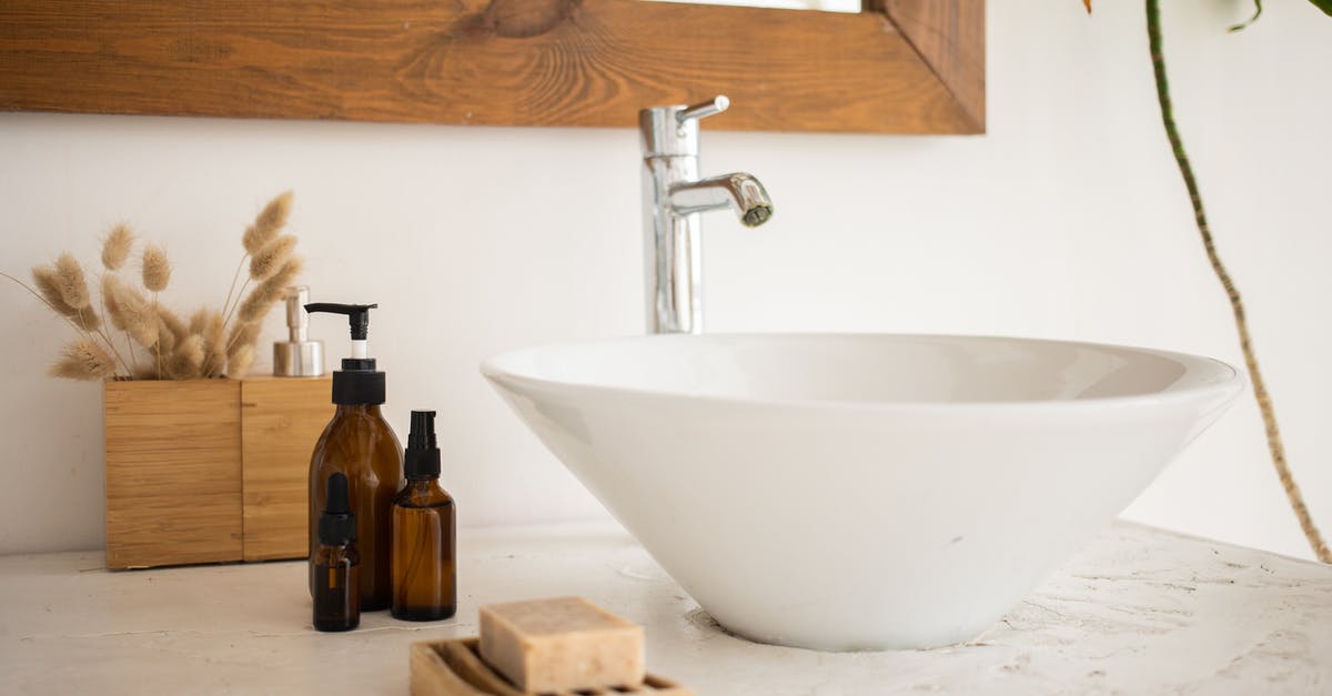 What happens when I tap the map? - Interior of bathroom table with soap and cosmetic oil placed near white sink and faucet under mirror in wooden frame in modern apartment What happens when I tap the map? - Interior of bathroom table with soap and cosmetic oil placed near white sink and faucet under mirror in wooden frame in modern apartment