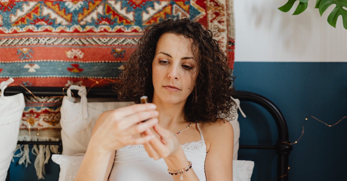What happens when you hit the hard limit in Idle Oil Tycoon? - Portrait of a Woman Holding a Small Bottle of Cosmetic Oil and Rug in Background