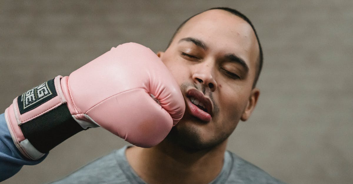 What if you don't hit Sans at the end of the fight? - Crop unrecognizable fighter in protective glove punching in face of young ethnic male opponent during boxing workout