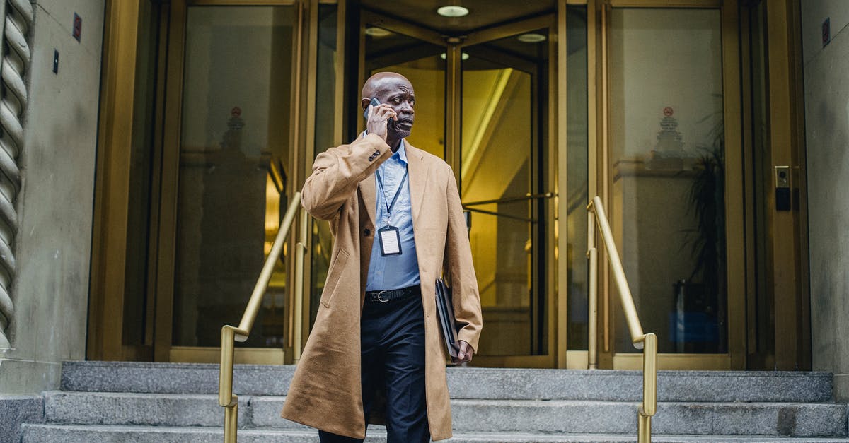 What incense to use for melee build? - Pensive black man talking on phone walking down stairs