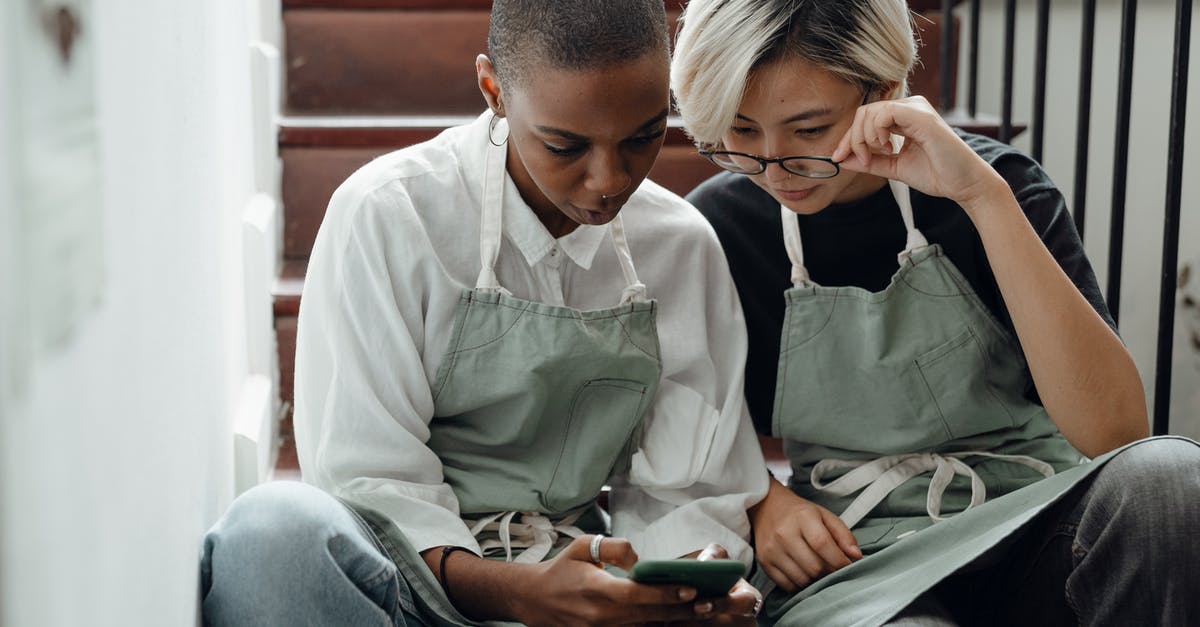 What information gets shared if I connect online? - Concentrated young diverse girlfriends watching video on smartphone