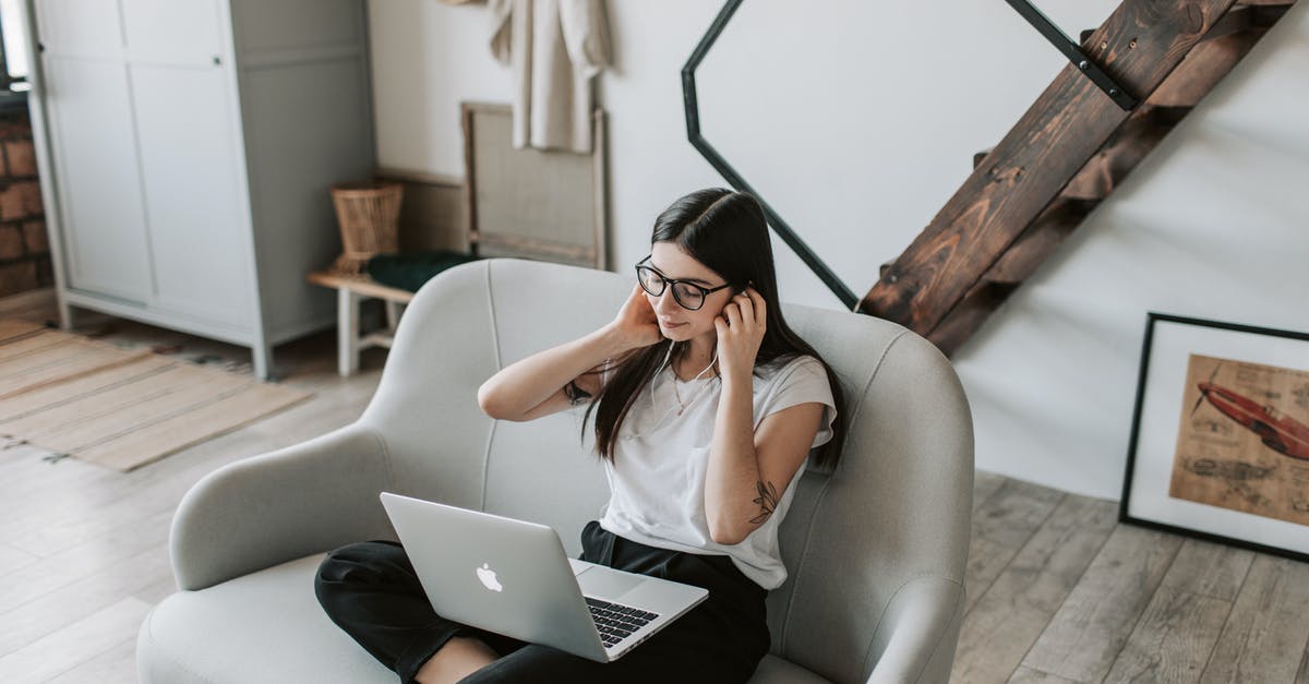 What is 16-bit music called? - Positive woman using earphones and laptop at home during free time What is 16-bit music called? - Positive woman using earphones and laptop at home during free time