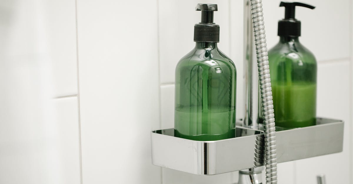 What is a dispenser - Green dispensers on shelf on shower system What is a dispenser - Green dispensers on shelf on shower system