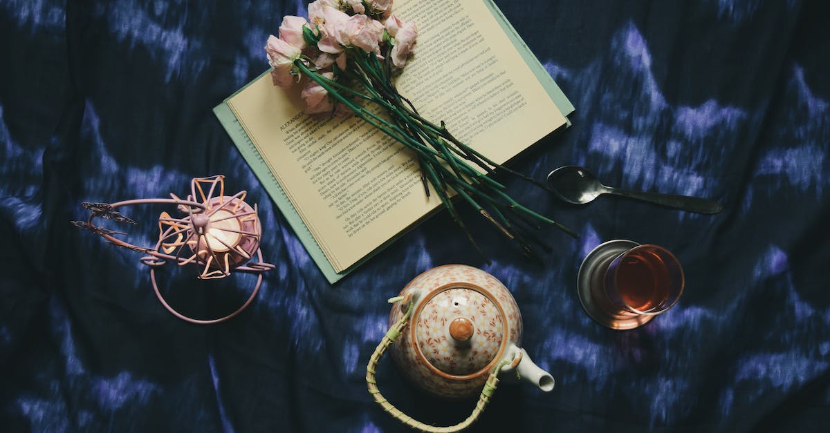 What is a good squad composition? - Top view composition of opened book and delicate pink flowers placed on dark blue silk cover near teapot glass of tea and creative candleholder What is a good squad composition? - Top view composition of opened book and delicate pink flowers placed on dark blue silk cover near teapot glass of tea and creative candleholder