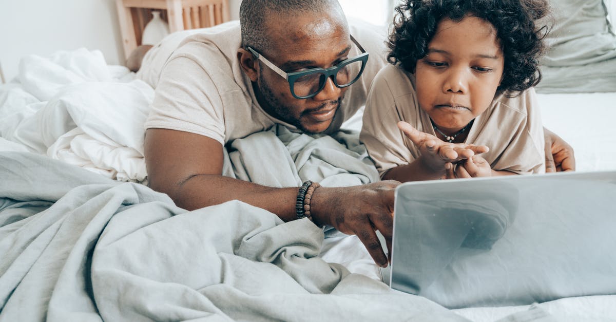 What is a remote hacking device takedown point? - Serious man and child with laptop on bed What is a remote hacking device takedown point? - Serious man and child with laptop on bed