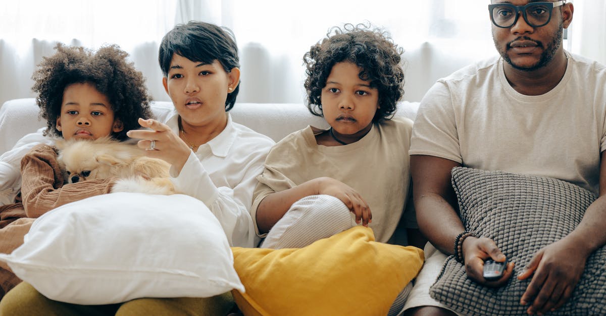 What is a remote hacking device takedown point? - Multiethnic family watching TV with dog on sofa What is a remote hacking device takedown point? - Multiethnic family watching TV with dog on sofa