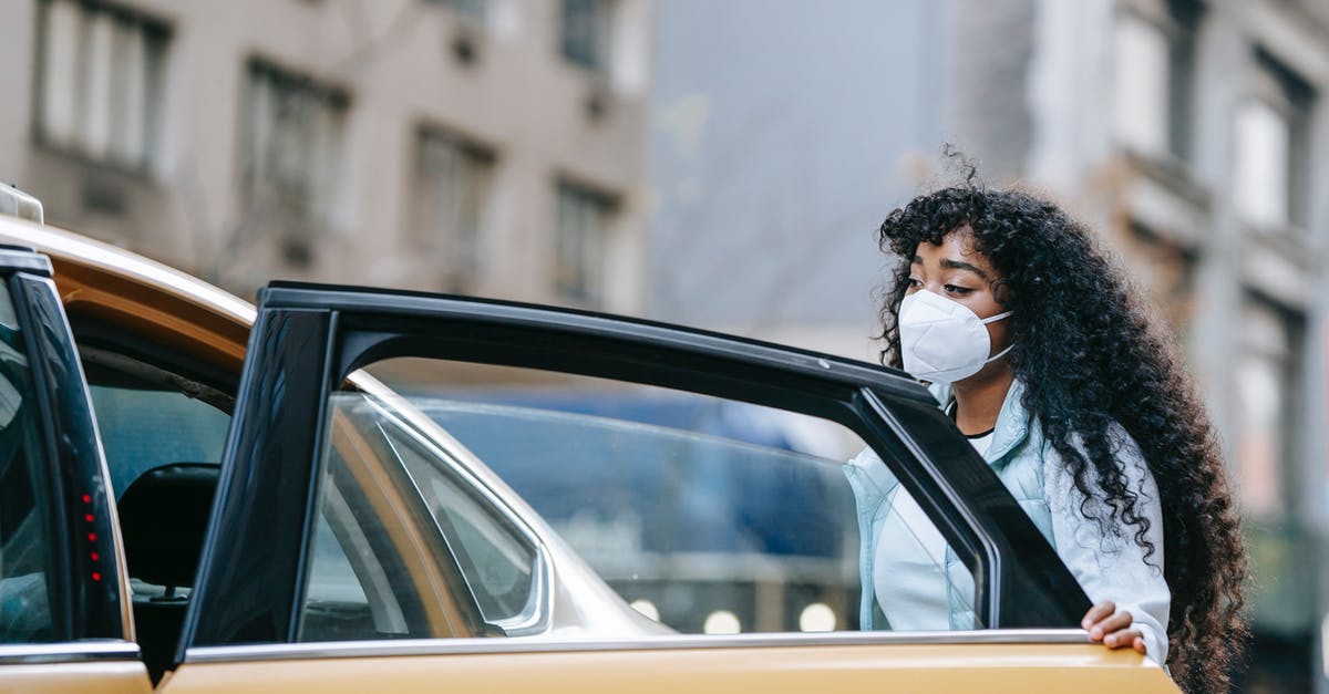 What is considered a normal car? - Serious young ethnic female getting into taxi on street What is considered a normal car? - Serious young ethnic female getting into taxi on street