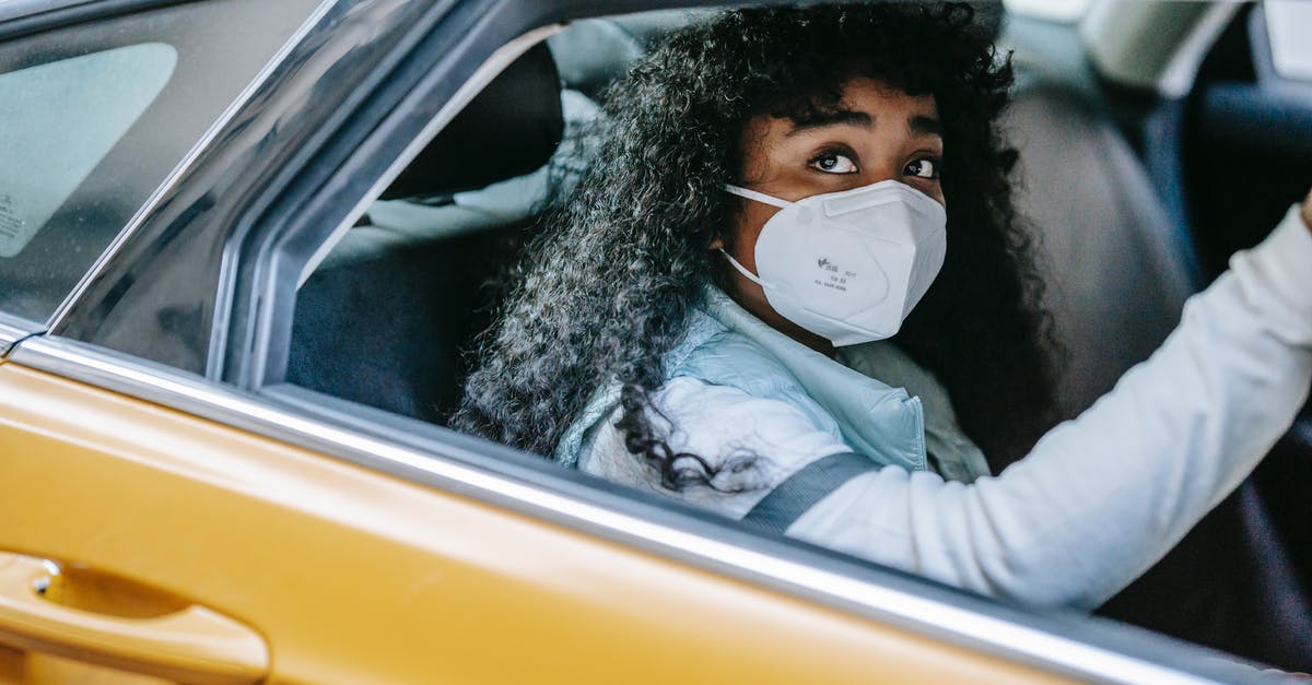 What is considered a normal car? - Thoughtful African American female with dark curly hair in medical protective mask sitting in taxi and looking away in daytime What is considered a normal car? - Thoughtful African American female with dark curly hair in medical protective mask sitting in taxi and looking away in daytime