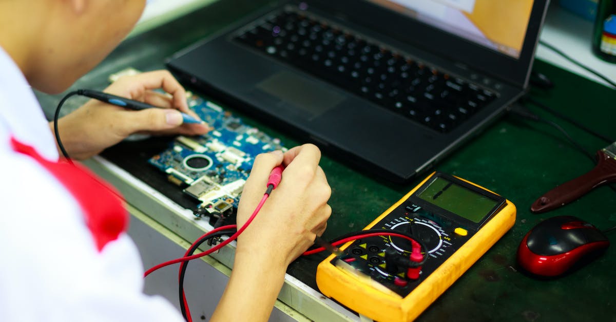 What is happening while I'm sitting at the load screen? [closed] - Man Soldering a Circuit Board