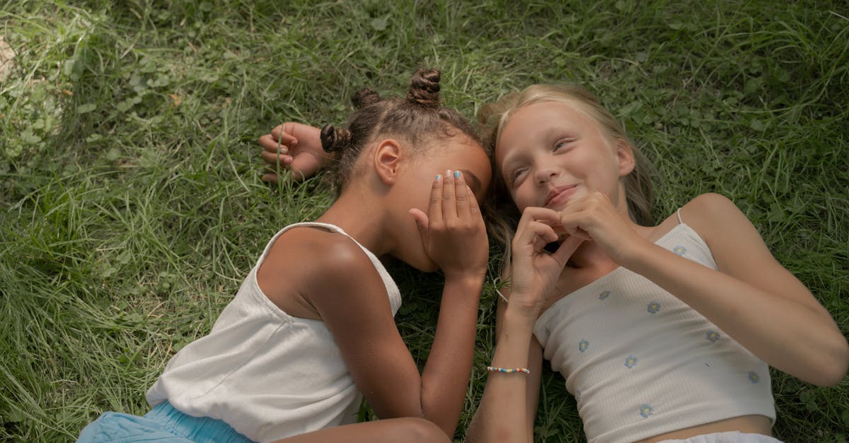 What is it like trading a CS:GO skin between two accounts? - Two Teenage Girls Laying on Green Grass