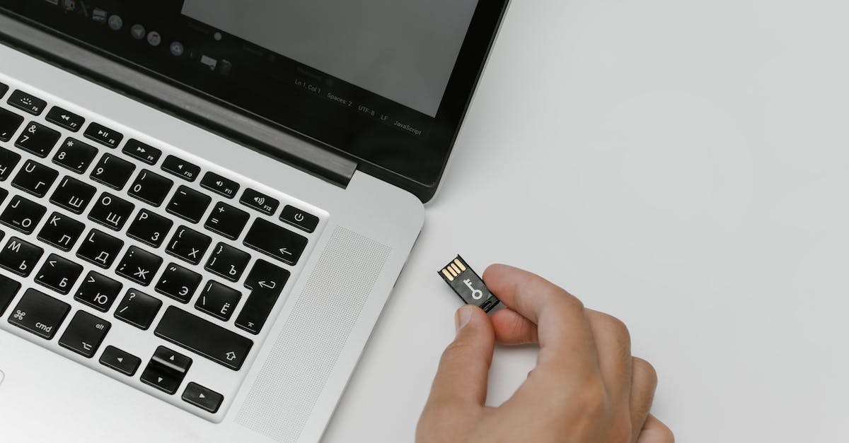 What is on the preinstalled SD card? - Person Inserting a Memory Card Into a Laptop