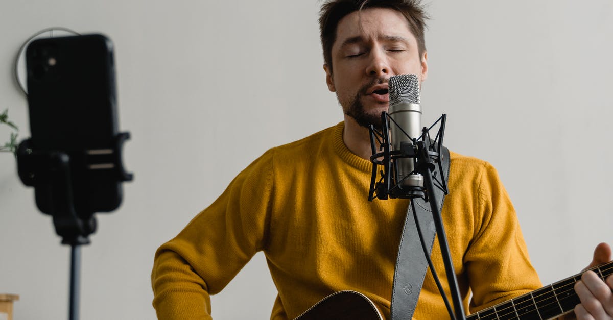 What is preserved when playing the Song of Time? - Photo of a Man in a Yellow Sweater Singing while His Eyes are Closed