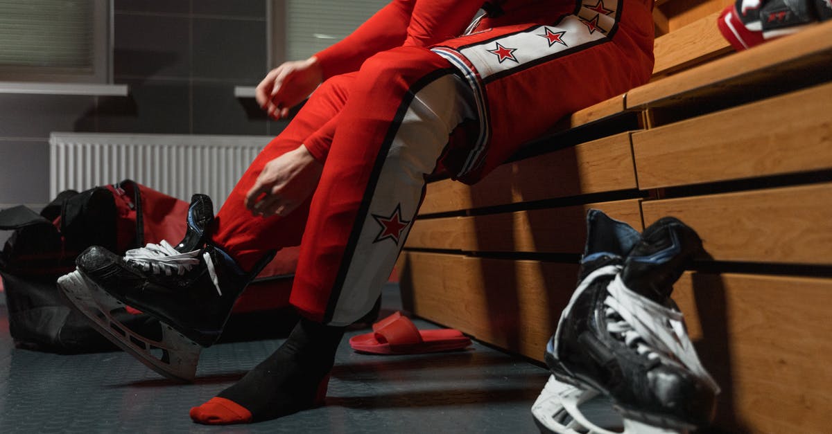 What is "OpenGL" and why did a player get banned for it? - A Person Putting On Ice Skates in the Locker Room