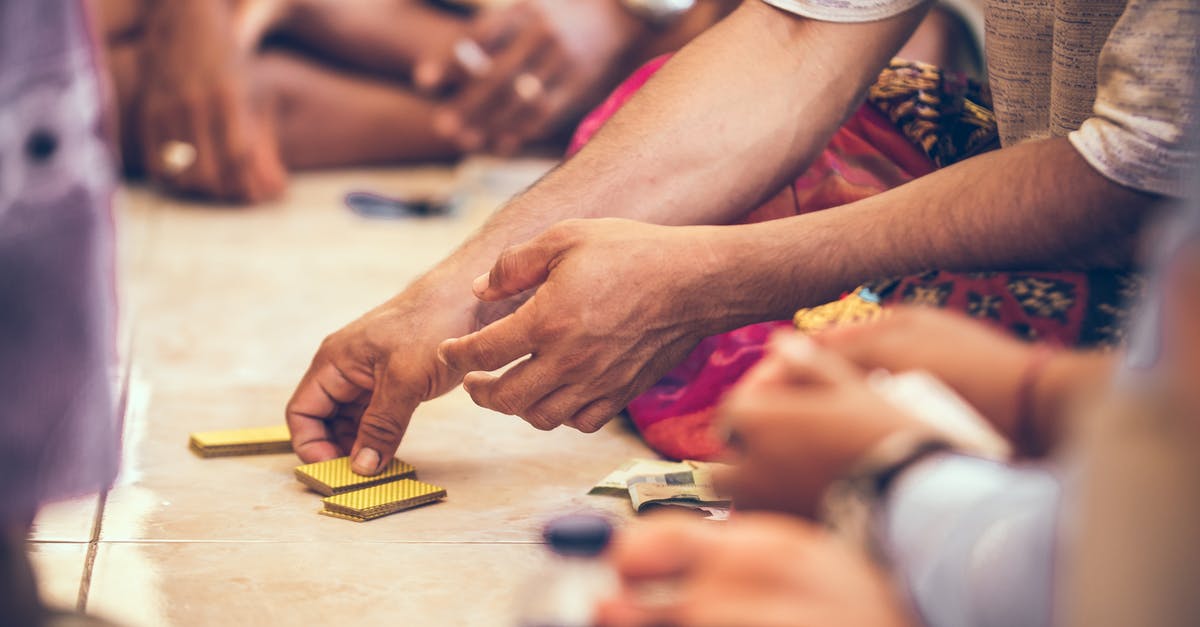 What is the advantage to playing a deck full of cards with locking abilities? - Close-up Photo of a Person's Hand Holding Playing Cards