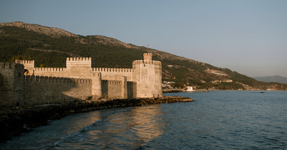 What is the benefit of "claiming" a Fort or other location for your guild? - Medieval fortress on seashore against grassy hill