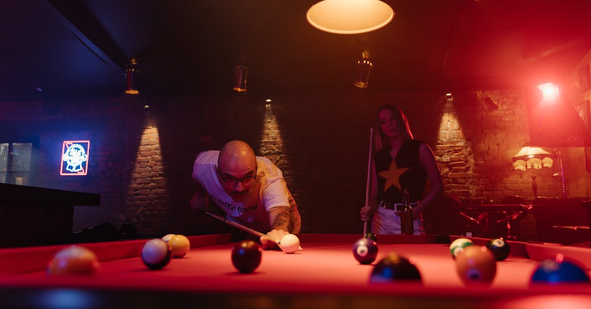 What is the best angle for an enderpearl if I am aiming for distance? - A Man Aiming at the Cue Ball with a Cue Stick