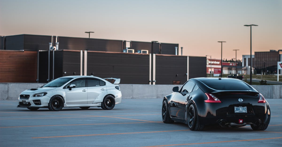 What is the best car and tuning setup for the career races? - Black and white race cars on parking lot at sunset What is the best car and tuning setup for the career races? - Black and white race cars on parking lot at sunset