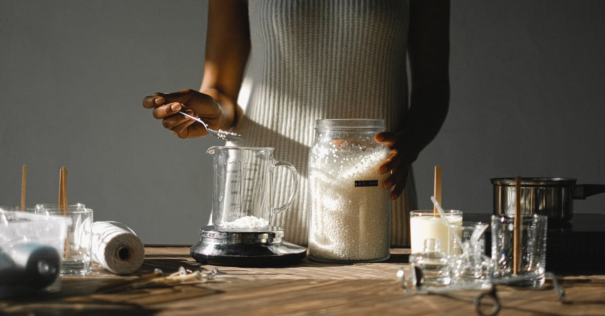 What is the best way to create a key mold farm - Crop black woman pouring wax into beaker What is the best way to create a key mold farm - Crop black woman pouring wax into beaker