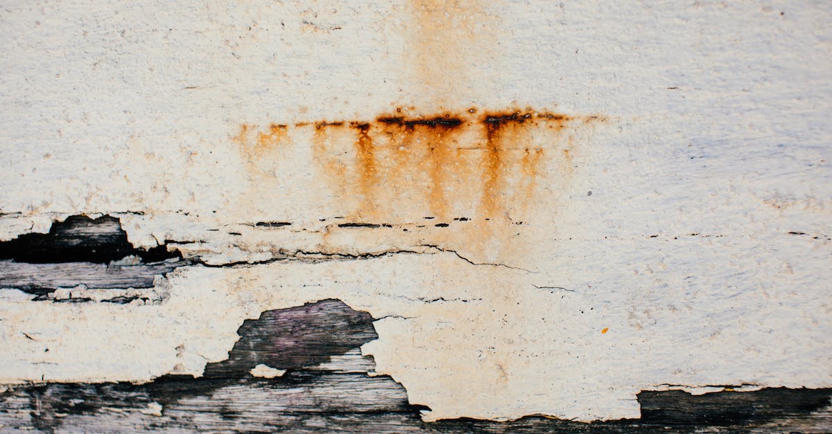 What is the best way to destroy spiked walls in Rust? - Textured background of weathered shabby cracked aged surface of old wall with plaster