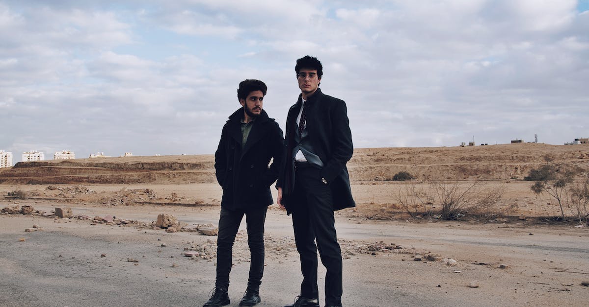 What is the black cloud that appears behind some of my characters? - Stylish ethnic men on shabby road under cloudy sky