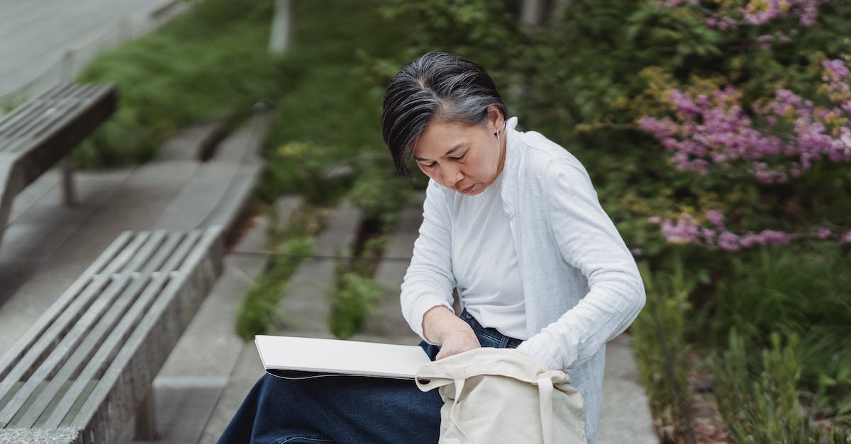 What is the chance of getting a reset bag? - Woman Sitting on a Bench while Looking at Her Tote Bag