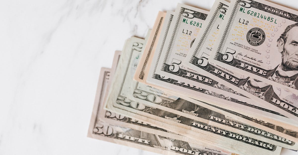 What is the conversion rate from USD to Nintendo Points? - Different dollar bills on marble surface What is the conversion rate from USD to Nintendo Points? - Different dollar bills on marble surface